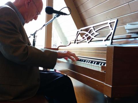 Herb Holt playing the piano in the fellowship