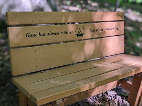 a bench with the text gone but always with us